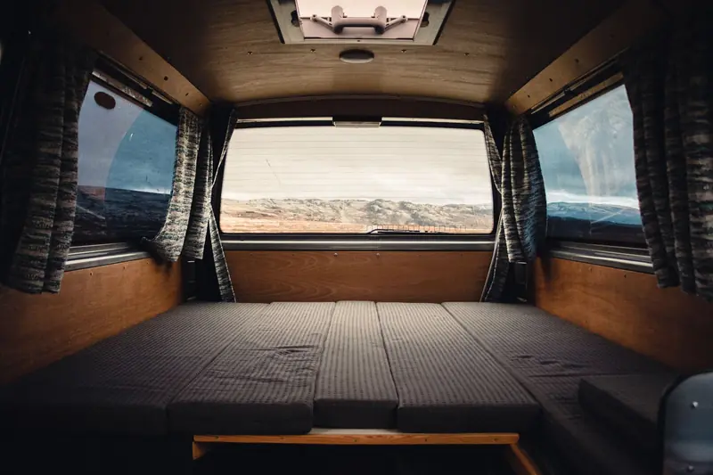 Comfortable and spacious camper van interior with scenic landscape view in Norway