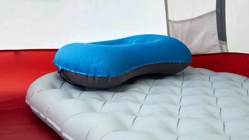 Detailed view of inflatable pillow on sleeping pad inside a tent, perfect for outdoor adventures